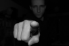 finger pointing with a man in background