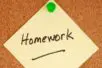 A yellow post-it with the word "homework" written on it is pinned to a cork board