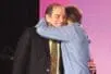 Rich Simon and Dan Siegel hug onstage