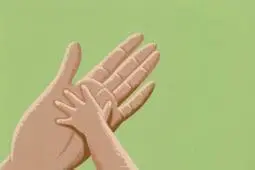 A small hand reaches to touch a larger one