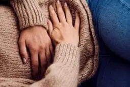 A woman holding her stomach
