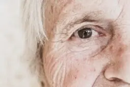 An older woman looks at the camera