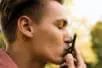 A man kisses his cell phone