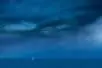 A small boat on the horizon