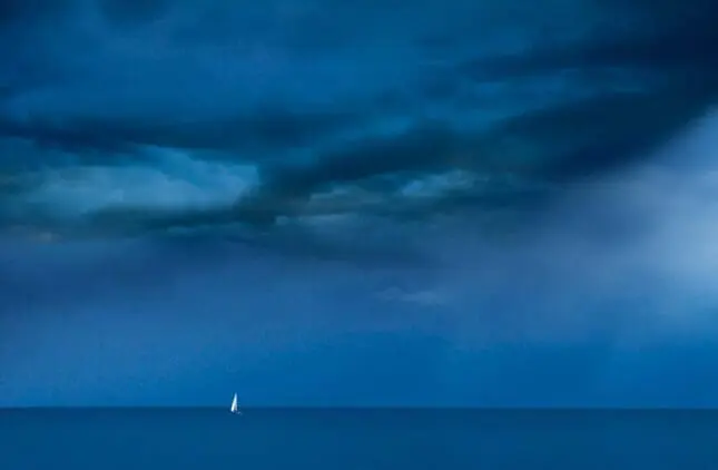 A small boat on the horizon