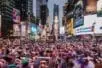 A crowd doing yoga in Times Square