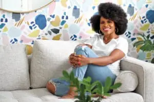 Nedra Glover Tawwab sits on a couch smiling