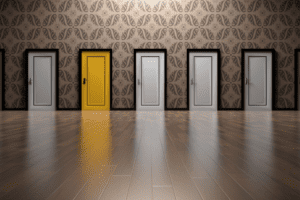 A rows of doors side by side, all in white except for one that is bright yellow