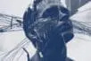 Grey and white picture of man's head crisscrossed with strings.