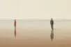 A woman and man at a distance facing opposite directions.