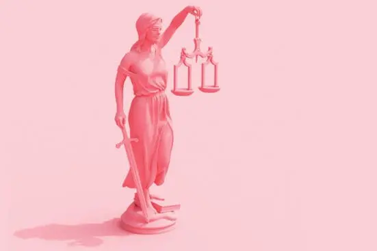 Lady justice holding scales and sword on pink background