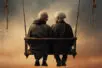 An elderly couple sit side by side on a swinging bench, turning to face each other