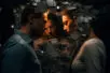 A man and woman face each other, faces framed by broken shards, while a third figure of a woman stands beyond them in the foreground