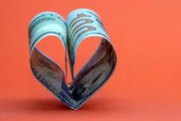 Two 100 dollar bills folded together to form a heart