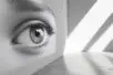 An image of an enormous eye painted across the surface of one wall in an empty room