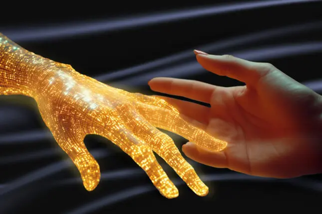 A human hand reaches out to one made up of glowing golden bands