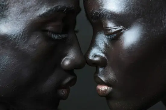 Close up image of a Black couple's faces with their noses nearly touching