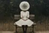 A figure in a dress sits on a bench, the head replaced by a dandelion with fluff drifting away