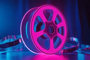 A neon film reel sits and glows
