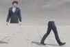 The top half of a man looks over at the bottom half of his body as it walks away