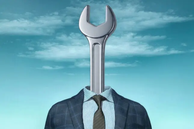 Image of a wrench wearing a business suit