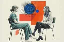 Two women sit, facing each other, with a tangle being sorted out between them