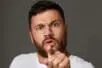 An angry man gestures toward the camera