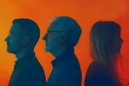 Profiles of an older man and younger man facing away from a younger woman