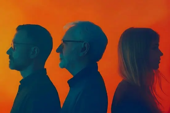 Profiles of an older man and younger man facing away from a younger woman