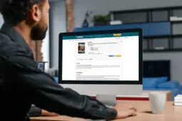 A man sits at a computer taking the CE test