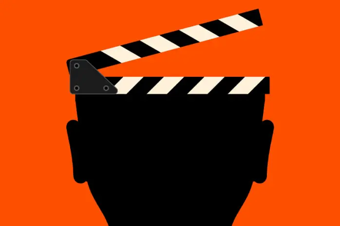 Image of a head of which the top is a director's slate about to snap shut