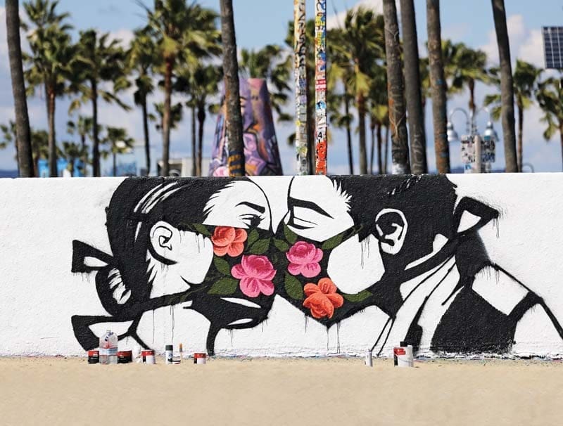 Graffiti of two masked people kissing