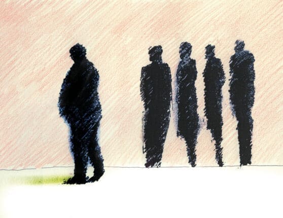 The silhouette of a man separate from a group of people