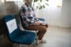 A man sitting a chair in a waiting room