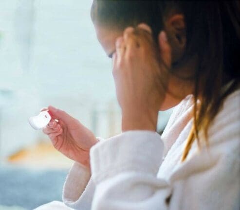 A woman looking at a pregnancy test