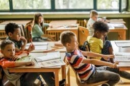 Children in school sit at their desks