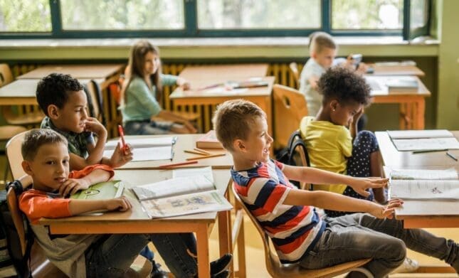 Children in school sit at their desks