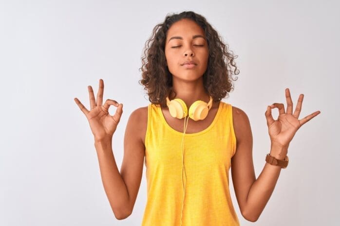 A woman with headphones meditates