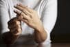 A woman takes her wedding ring off