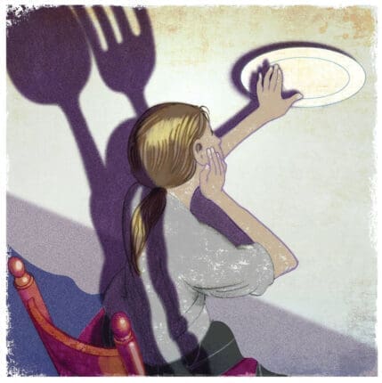 A girl pushing away a plate