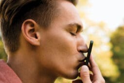 A man kisses his cell phone