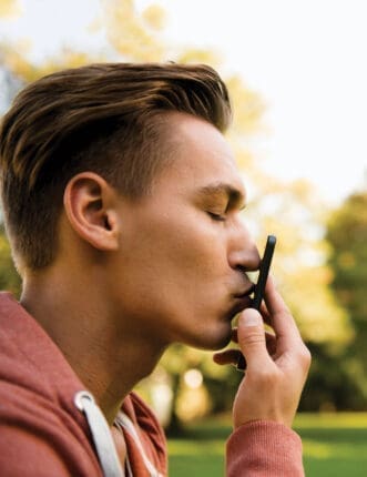 A man kisses his cell phone