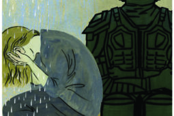 A woman cries next to an armored man