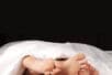Pairs of feet in bed