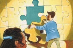 A woman watches as a man inserts the final piece of a large puzzle