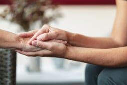 Two people hold hands