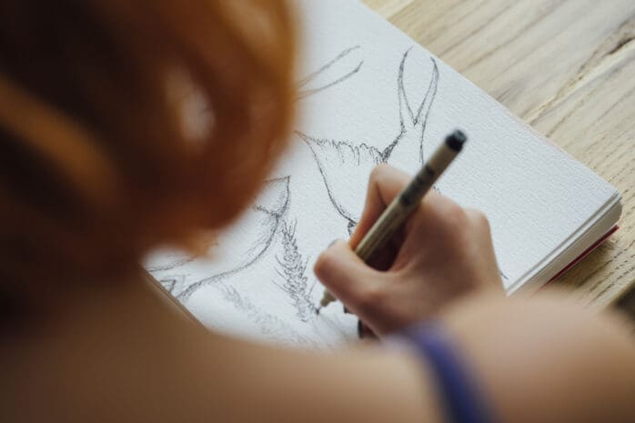 A person draws on a sketchpad