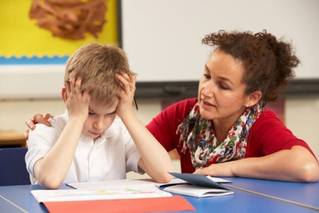 A teacher helping a frustrated student