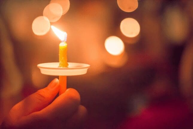 A candle held at a vigil