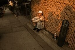 A man sitting on the curb of the sidewalk / Photo by Mental Health America (MHA)